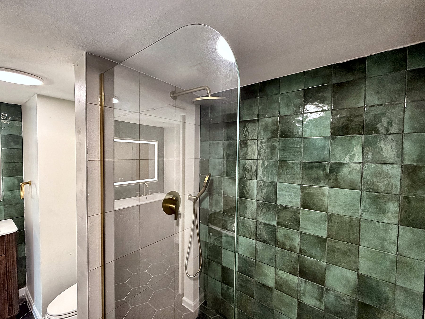 Main bathroom walk-in shower with green zellige tile