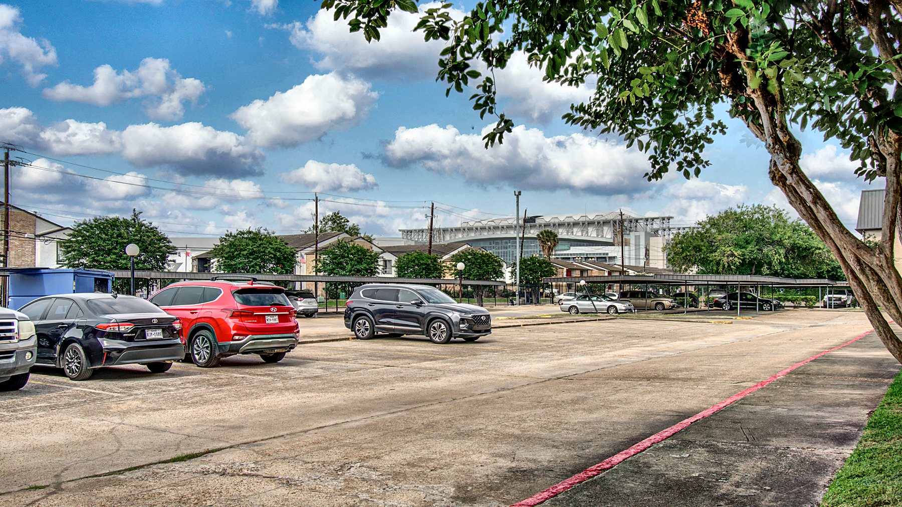 NRG Stadium visible above the rooftops from the community parking lot