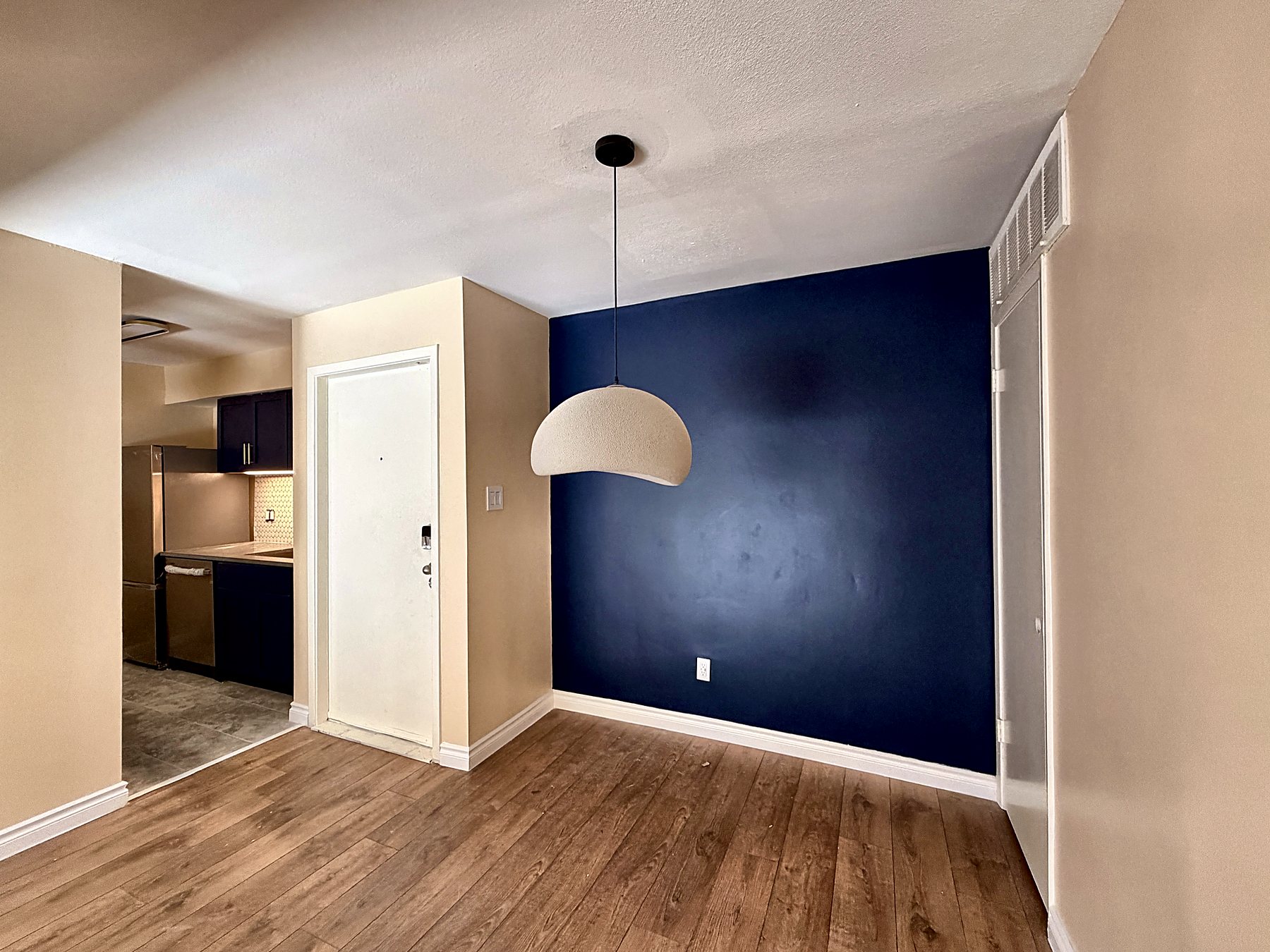Dining area with pendant light and entry door
